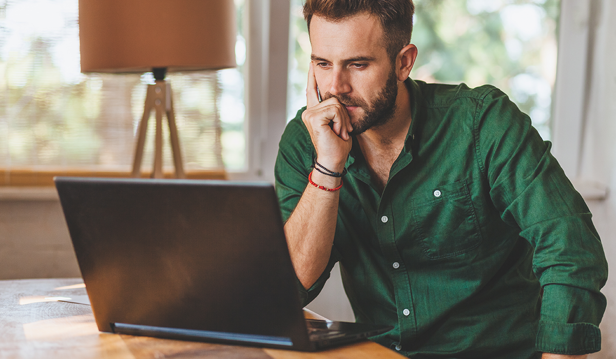 man looking at his computer man looking at his computer